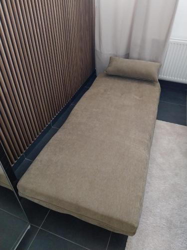 a bed in a corner of a room at Boom Station & Schorre Suites in Boom