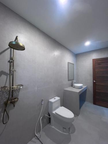 a bathroom with a white toilet and a sink at Tropical villa - Private pool - 3 bedrooms in Ko Phangan