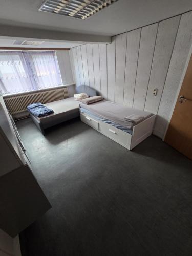 a small bedroom with a bed and a window at Heritage Timber Stay in Wendeburg