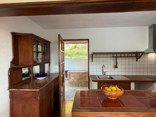 a kitchen with a bowl of fruit on a table at Tramuntana Sunset in Port de Soller