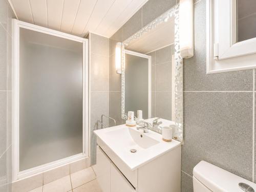 a bathroom with a white sink and a mirror at Le St Joseph in Vérin