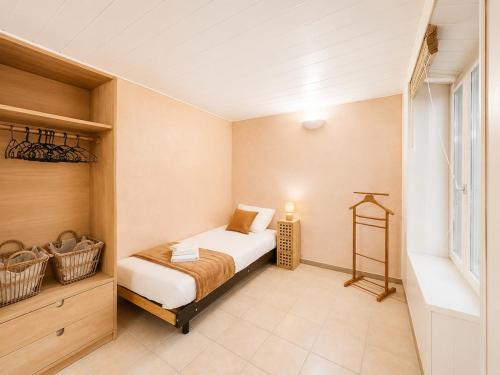 a small bedroom with a bed and a window at Le St Joseph in Vérin
