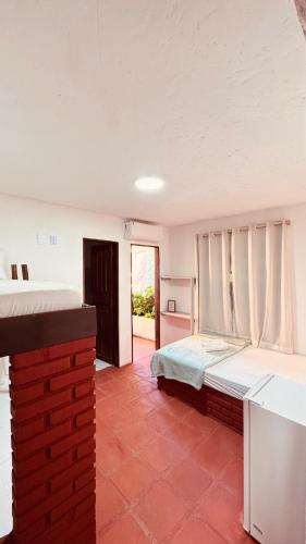 a bedroom with a large bed in a room at Uma Janela Para o Sol in Morro de São Paulo