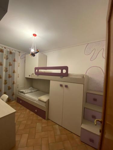 a small room with a bunk bed and a table at Le case della baracchina in Pisa