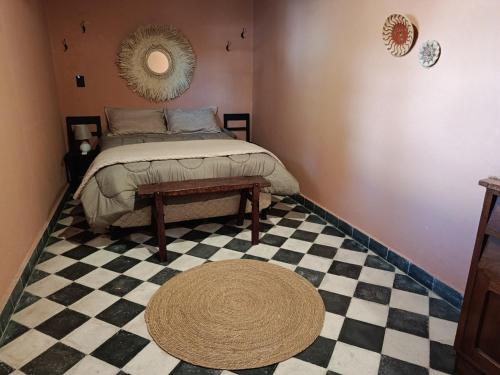 a bedroom with a bed and a checkered floor at Casa El Jardín Centro Histórico in Asunción