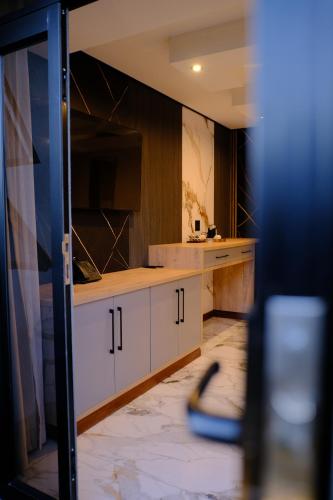 a kitchen with white cabinets and a counter top at The ATRIUM BOUTIQUE HOTEL in Polokwane