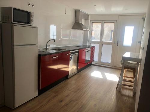a kitchen with a refrigerator and a stove top oven at Entre Micelios in Vinuesa