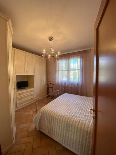 a bedroom with a bed and a television in it at Le case della baracchina in Pisa