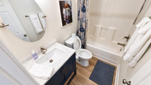 a bathroom with a sink and a toilet and a mirror at 2Br 2Ba Condo on Golf Course in Pawleys Island