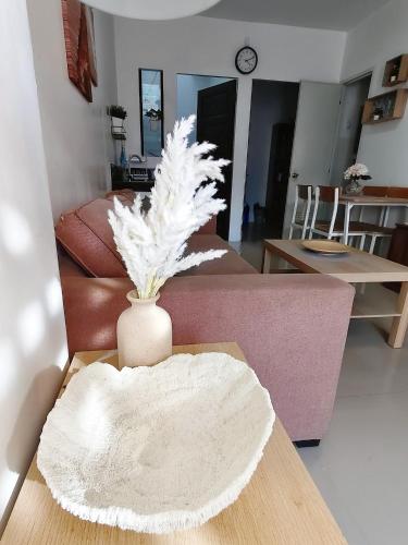a living room with a vase on a table at Graceland in Lapu Lapu City