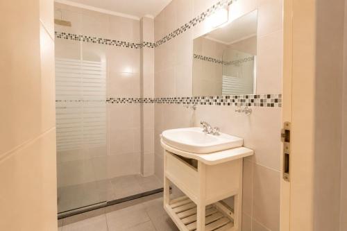 a white bathroom with a sink and a shower at Altos de Alem in Federación