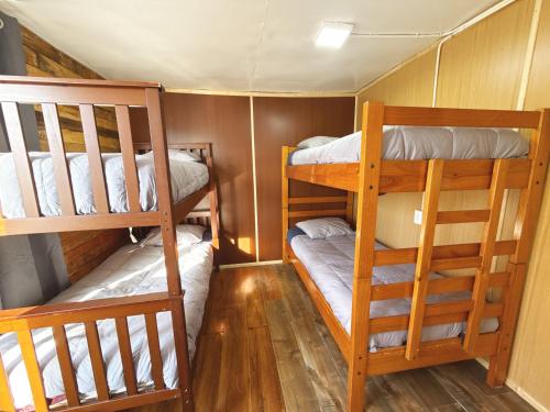 a small room with two bunk beds in it at Hostel 53 Sur in Puerto Natales