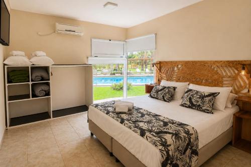 a bedroom with a bed and a large window at Altos de Alem in Federación