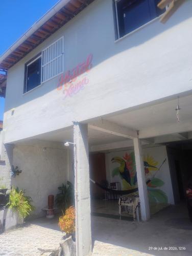 a white building with a sign that reads attack sauce at hostel xamã in Flecheiras