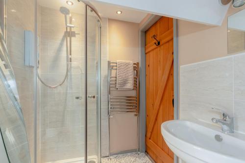 a bathroom with a shower and a sink at Three Peaks Central Cottage, Settle, 3Bed 2Bath in Settle