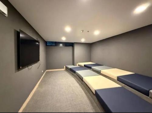 a conference room with blue and white couches and a flat screen tv at Imperial house in Envigado