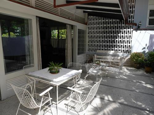 a patio with a table and chairs on a porch at New Manila Suites in Manila