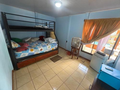 a bedroom with a bunk bed and a window at Elsie Place in San Mateo