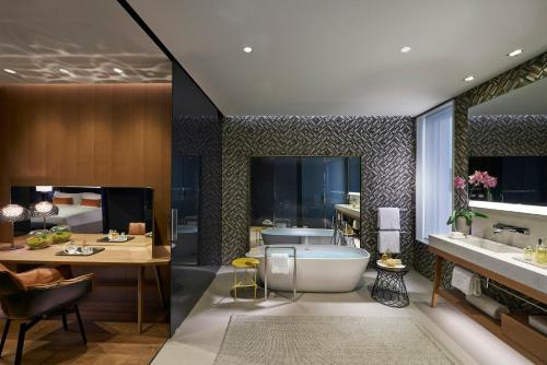a bathroom with a tub and a sink at Mandarin Oriental, Barcelona in Barcelona