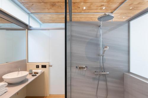a bathroom with a shower and a sink at Anassa House with Rooftop Jacuzzi in Vamos