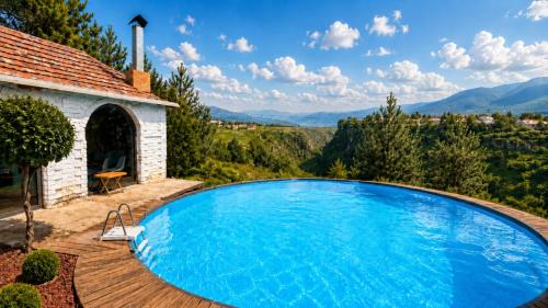 a swimming pool on a wooden deck next to a house at Sochi Resort-Pine Garden Boutique Hotel and Pool Stepanavan in Stepʼanavan