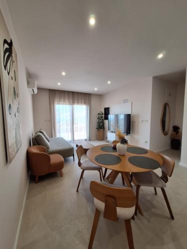 a living room with a table and chairs and a couch at 4 stars - apartments Senj in Senj