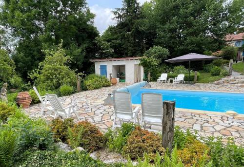 a yard with chairs and a swimming pool at Villa Felinas in Ahun