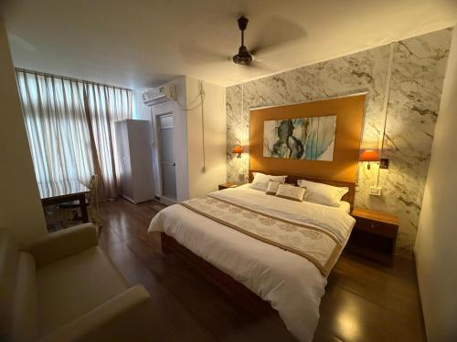 a bedroom with a large bed in a room at Kesang Stay in Diphu