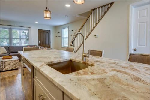 a kitchen with a sink and a living room at Bradley Beach Compound in Bradley Beach