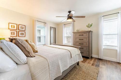 a bedroom with a bed and a ceiling fan at Bradley Beach Compound in Bradley Beach