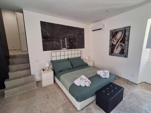 a bedroom with a bed with towels on it at Sogno nella Corte in Bitonto