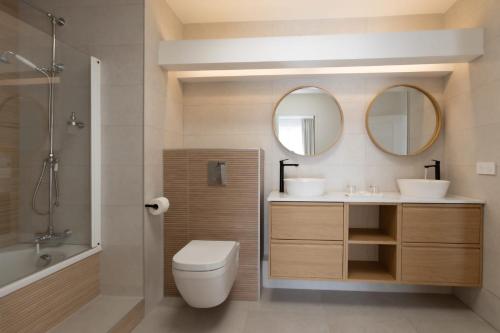 a bathroom with a toilet and a sink and mirror at Hotel Maison Forge - Ex Hotel ASTORIA- Saint Etienne-Centre des Congrès- in Saint-Étienne