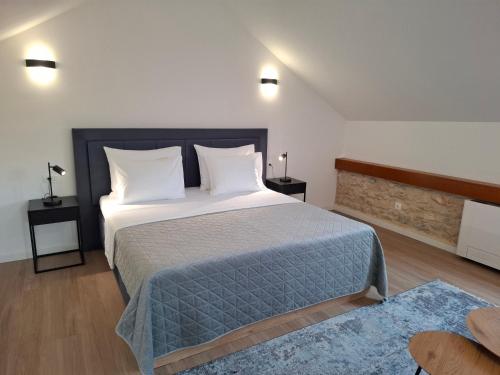 a bedroom with a large bed with white pillows at Hidden Heritage in Skradin