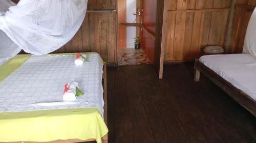 a small room with two beds in a house at Cabaña Perla del Cabo in Nuquí