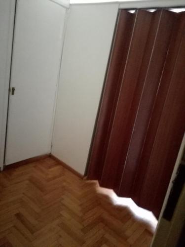 an empty room with a door and a wooden floor at Centro Obelisco in Buenos Aires