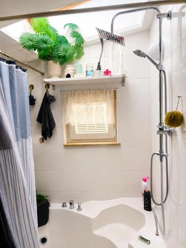 a bathroom with a white tub and a sink at ROSE ROOM for 4 guests in green Rose resort Ljubljana in Ljubljana