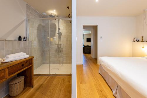 a bedroom and a bathroom with a shower at Domaine Croix-Maro in Caux