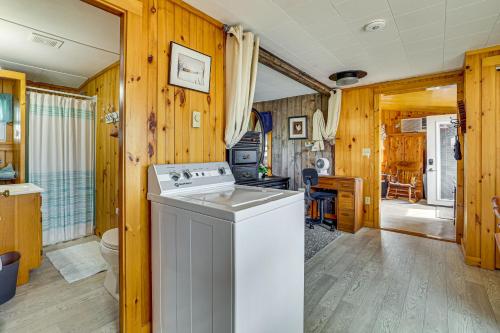 a kitchen with a white stove top oven in a room at Sunset Views & Deck: Lake Champlain Cottage! in Swanton