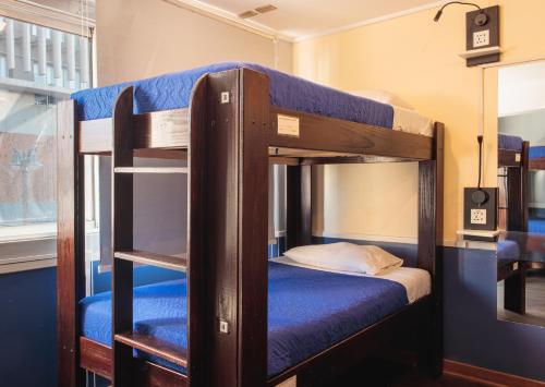 a couple of bunk beds in a room at Guanako Rooftop Hostel in Santiago