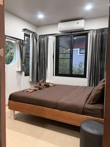 a bedroom with a bed with a dog laying on it at CS phangan Villa in Ko Phangan