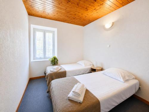 a room with two beds and a window at Le Condrieu in Vérin