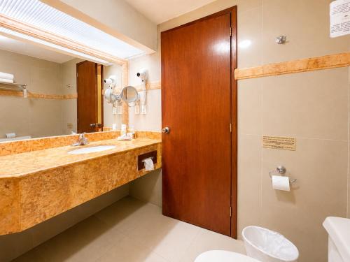 a bathroom with a sink and a mirror at Gran Real Yucatan in Mérida