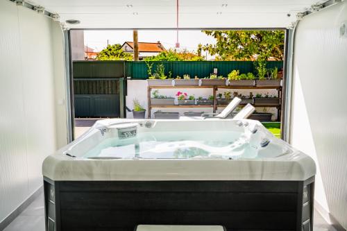a bath tub in a room with a large window at Pátio Mariano in Serra de El-Rei