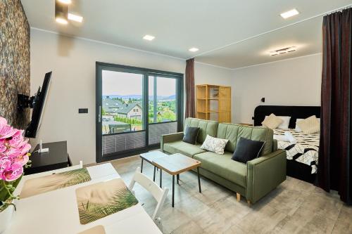 a living room with a couch and a bed at Apartamenty w Żywcu u Astrid in Żywiec