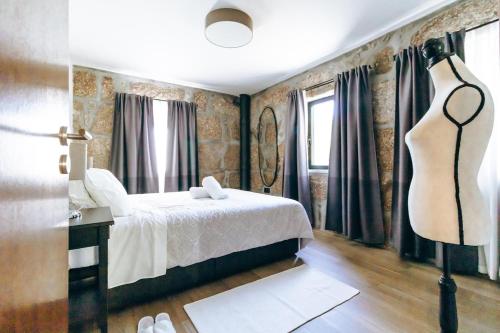 a bedroom with a bed and a dresser in it at Casas de Mirão in Baião