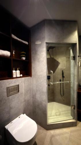 a bathroom with a shower and a toilet at Abbi Holiday - Jaffna Hotel in Jaffna