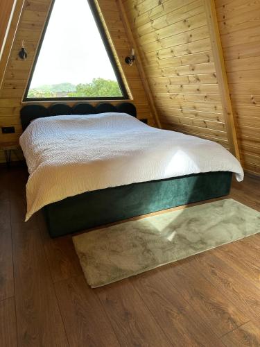 a bed in a room with a window at The Peak in Zărneşti