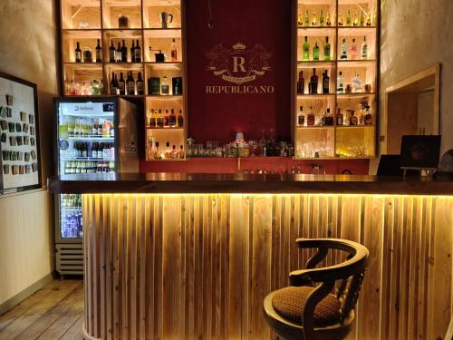 a bar with a chair in front of a counter at Republicano Hostal in Jericó