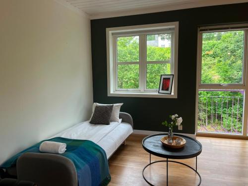 a living room with a couch and a table at Spacious Apartment - Central Voss - Free Parking in Vossevangen