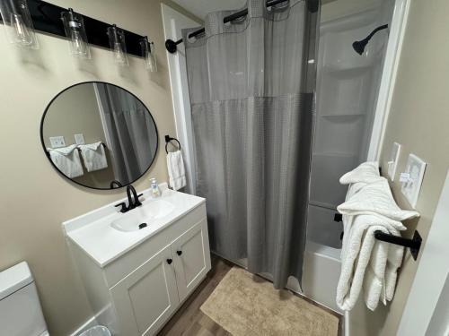 a bathroom with a sink and a shower with a mirror at little mountain haven in Mount Torry Furnace